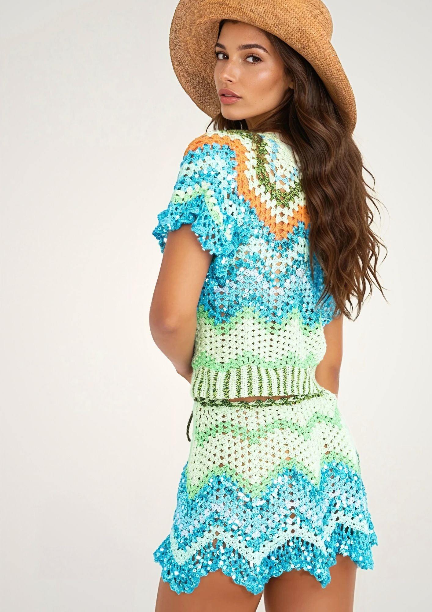 A girl in a vacation style handcrocheted top and mini skirt with zigzag pattern