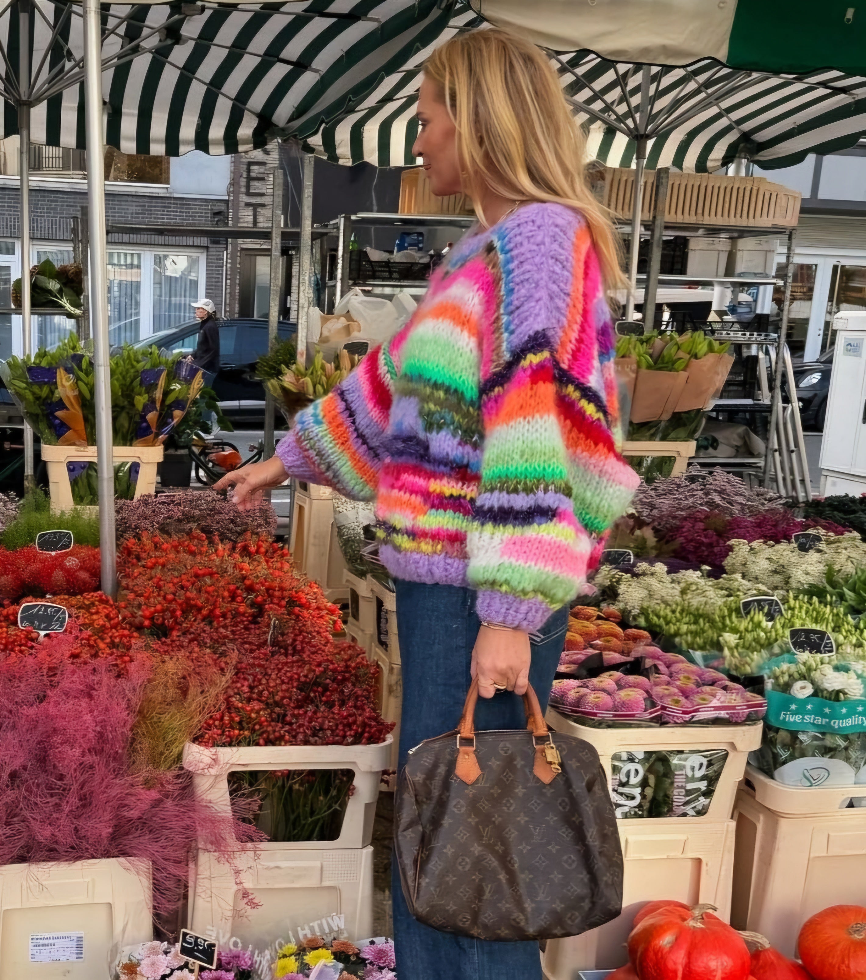 A colorful highend handknitted sweater in mohair worn byEllemieke Vermolen on the market in Knokke