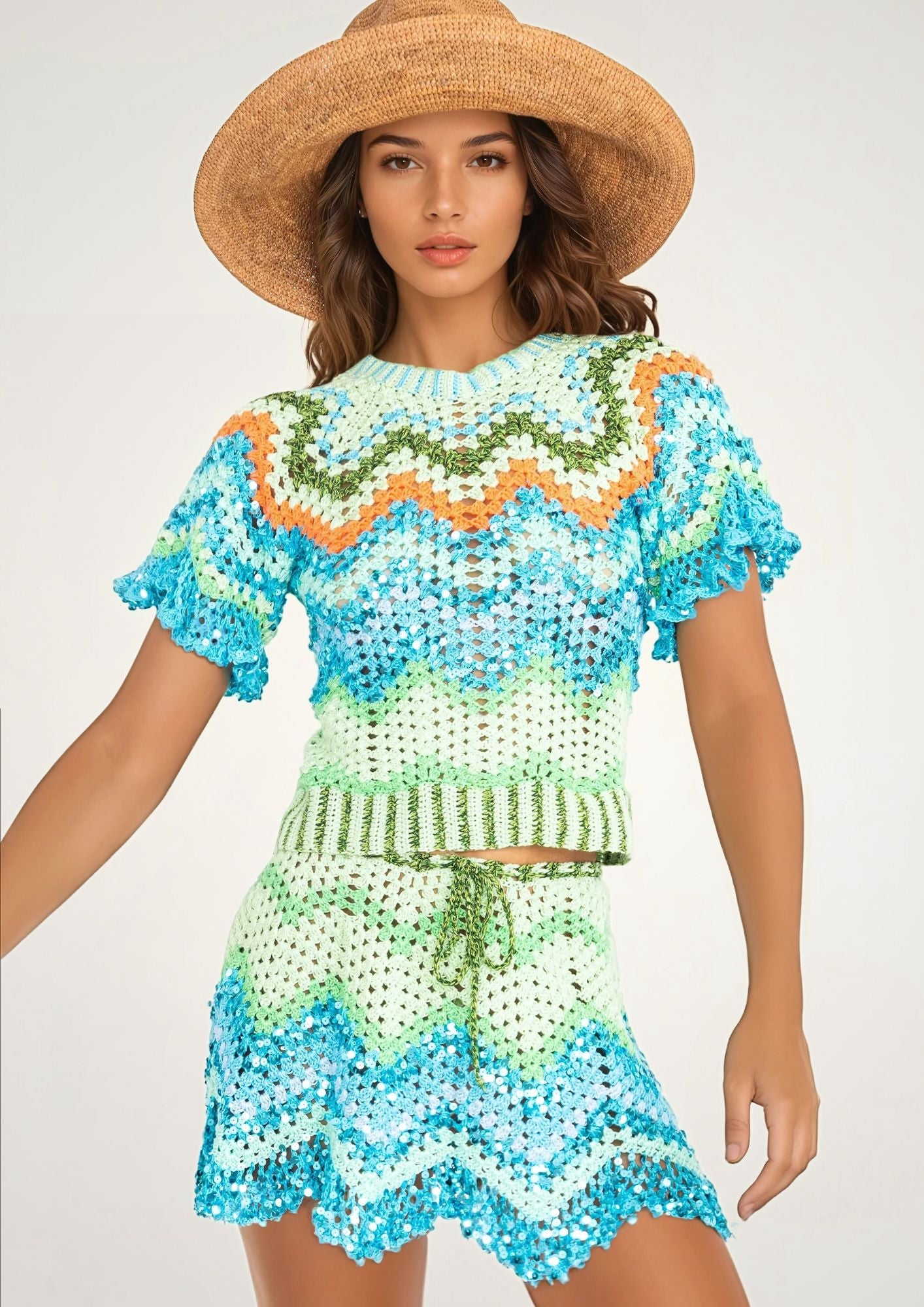 A girl in a handcrocheted top and beach skirt with zigzag pattern, with strawhat